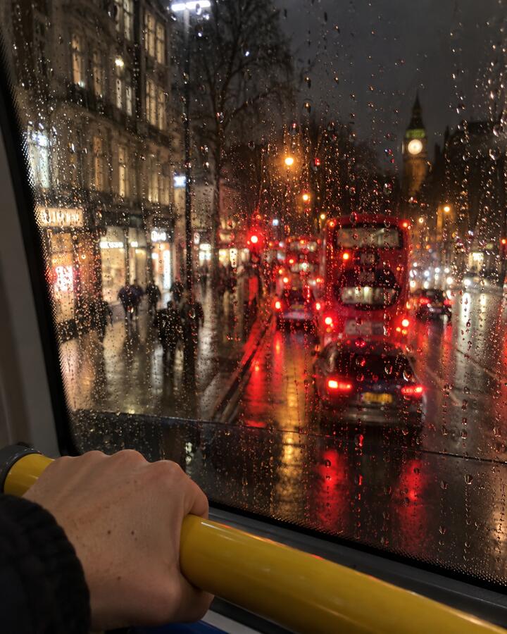 Rain on a London bus window at night